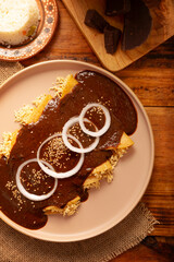 Chicken Enmoladas. In Mexico they are called Enchiladas de Mole Poblano, corn tortillas folded and filled with shredded chicken bathed in a sauce of chilies and many more ingredients called mole.