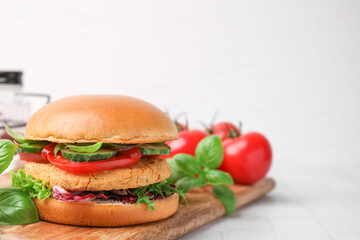 Delicious vegan burger with chickpea cutlet on white tiled table. Space for text