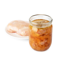 Canned meat in jar and raw chicken fillet isolated on white