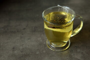 A Cozy and Warm Cup of Herbal Tea Sitting on a Rustic Surface for Full Enjoyment