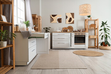 Interior of kitchen with counters, shelf units and paintings