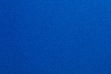 A blue background with a few white dots, textured origami paper backdrop