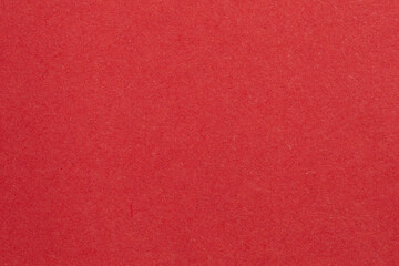 A red background with white object in the middle, textured origami paper backdrop