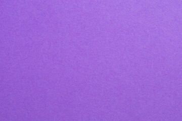 A purple background with a white dot in the middle, textured origami paper backdrop