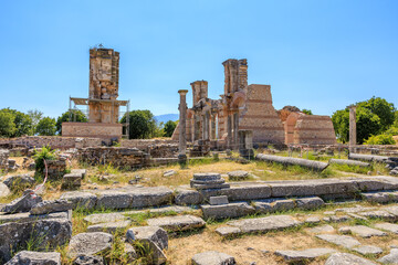 The ruins of an old building sit in a grassy field. Ruins of the ancient city of Philippi, Greece