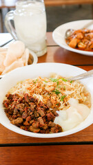 Bubur Ayam: Chicken rice porridge, served with soy sauce, crispy crackers, and fried shallots.