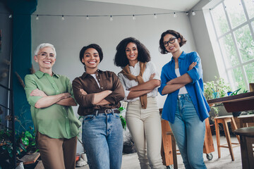 Obraz premium Portrait of team ambitious business women posing crossed arms modern interior office indoors