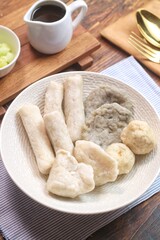 Pempek or empek-empek is a savoury Indonesian fishcake delicacy, made of fish and tapioca, from Palembang, South Sumatera, Indonesia. Pempek is served with rich sweet and sour sauce called cuko