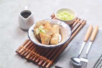 Pempek or empek-empek is a savoury Indonesian fishcake delicacy, made of fish and tapioca, from Palembang, South Sumatera, Indonesia. Pempek is served with rich sweet and sour sauce called cuko
