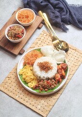 Nasi gurih is an Indonesian steamed rice cooked in coconut milk and spices dish originally from...