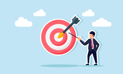 businessman holding a stick and pointing at a target board, illustration of educating the importance of achieving business targets for better business performance