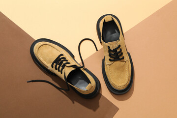 Stylish boots with a thick sole on a brown background
