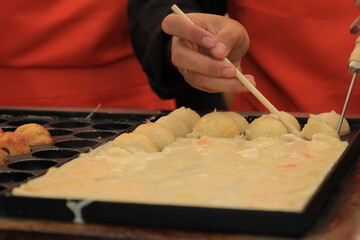 Process to Cooking Takoyaki on hot pan, famous food Osaka Japan street food