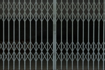 Closed folding steel door of the house, shop. Iron slide door of the home 