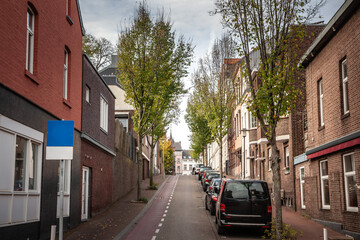 Fototapeta premium Panorama of typical dutch street in countryside village of netherlands in Vaals Limburg with houses & residential buildings in the center capturing charm of rural life & traditional Dutch architecture