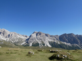 landscape in the mountains, Blue skies on a summers day in Europe Alpine region. Hiking hut-to-hut in the Dolomites. 