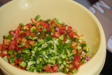 finely cutting the peppers on a wooden bell