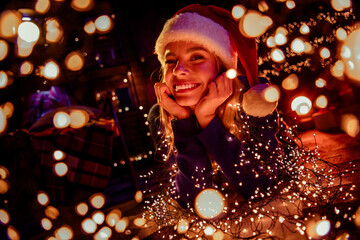 Photo of lovely young woman dreamy lying floor dressed christmas outfit tradition garland lights atmosphere decor house indoors room