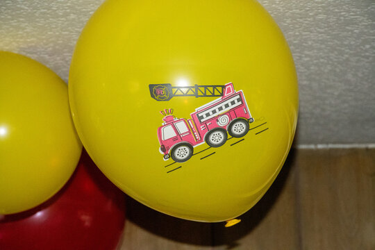 Yellow Bollon with a fire truck on it 
