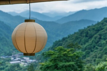 Obraz premium Explore the tranquil beauty of a lantern hanging over a serene mountain landscape in nature's embrace