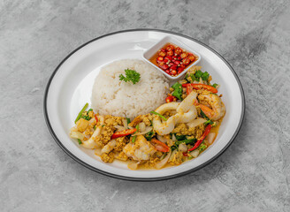 Delicious stir-fried seafood with jasmine rice and spicy sauce for a flavorful meal experience