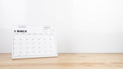 March calendar on wood desk white background.
Mar 2025 desktop calender agenda. 