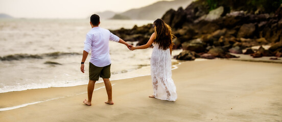 bride and groom on a beach, dressed in white for wedding, new year, party, family, young couple