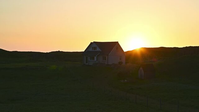 Summer sunset behind Scottish cottage in the Outer Hebrides, Isle of Lewis
