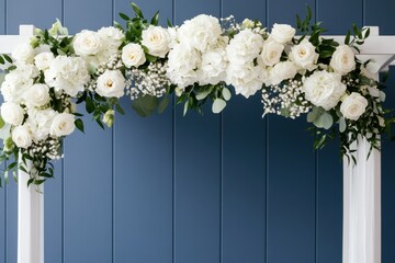 Romantic wedding venue with floral ceremony concept. A beautiful floral arrangement featuring white roses and greenery on a white arch against a blue background, perfect for weddings or special events