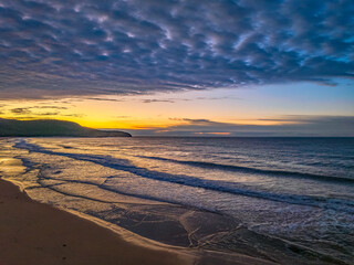 Winter seascape views over the beach with high and medium cloud cover