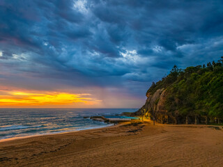 Pretty Sunrise at the seaside with rain clouds