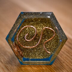 High resolution image of a single isolated beautiful one of a kind hand made Orgone pyramid generator containing crystals