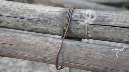 Rusty Wire Binding Two Wooden Logs