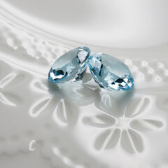 Topaz on white plate. blue stone.