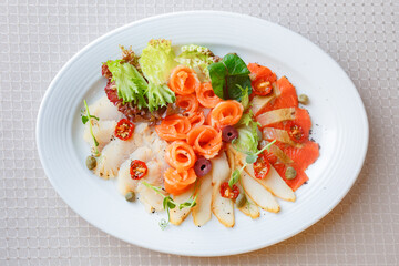 Close-up of healthy omega 3 rich salad with salmon, tomatoes and leaves