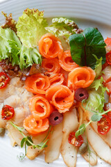 Close-up of healthy omega 3 rich salad with salmon, tomatoes and leaves