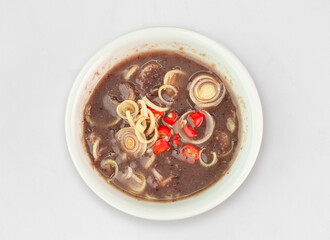 Shrimp paste with sliced lemongrass  and chilli Sauce. Shrimp paste chili paste in white bowl. Mam tom 