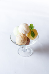 coloured ice cream in a glass bowl on a white background isolated
