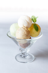 coloured ice cream in a glass bowl on a white background isolated
