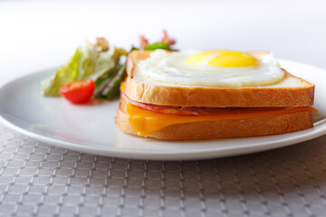 Homemade breakfast scrambled egg sandwich with tomatoes cherry on white table, healthy breakfast fried egg on toast with fresh and nutritious ingredients