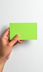 Fototapeta premium Hand Holding Neon Green Card - Isolated Product Photography