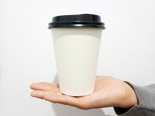 Paper cup in hand front view