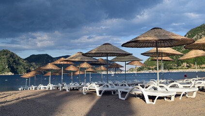 Sunbeds and umbrellas on the beach of Icmeler. Marmaris