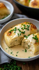 Creamy maultaschen dumplings on plate with savory sauce and chives garnish