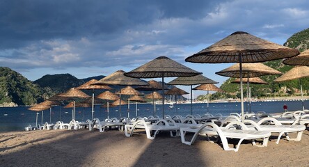 Sunbeds and umbrellas on the beach of Icmeler. Marmaris