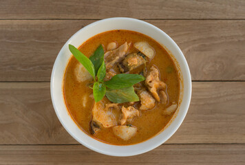 Spicy chicken curry on table background, Hot thai red curry, Popular asian food. top view