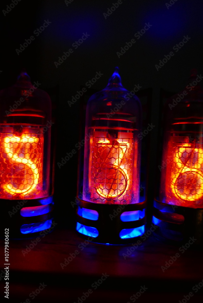 Poster retro nixie lamp indicator clock on dark background. the nixie tube indicator of the numbers of retr