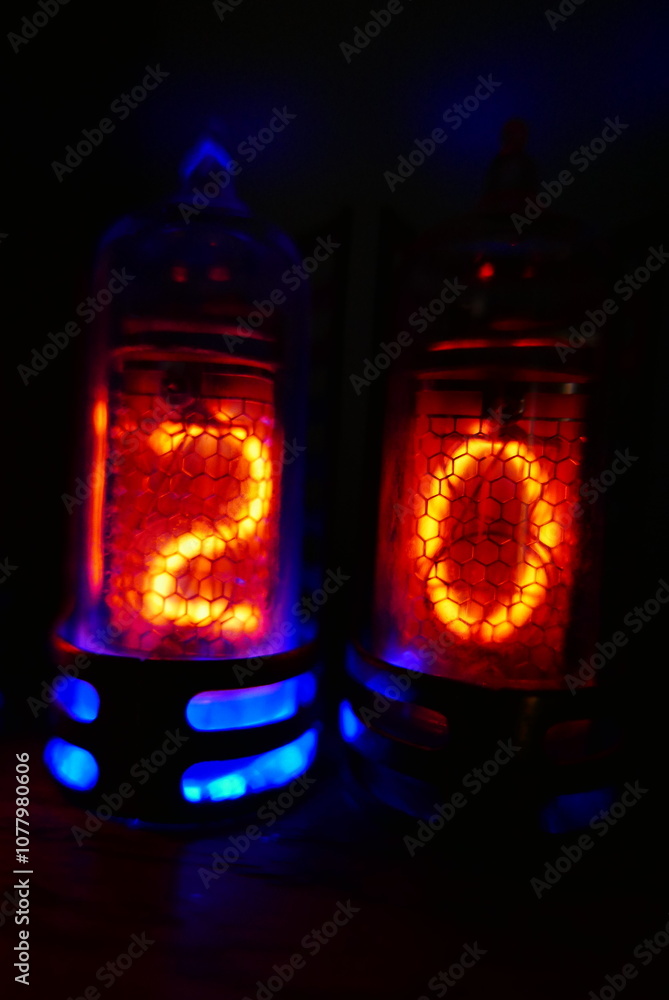 Poster retro nixie lamp indicator clock on dark background. the nixie tube indicator of the numbers of retr