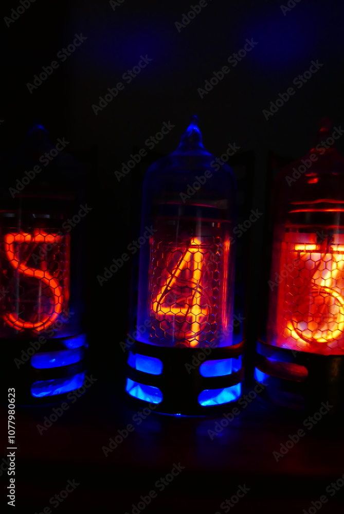 Poster retro nixie lamp indicator clock on dark background. the nixie tube indicator of the numbers of retr