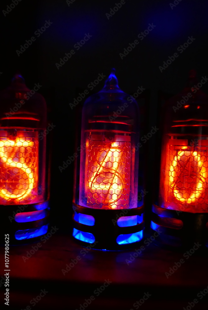 Poster retro nixie lamp indicator clock on dark background. the nixie tube indicator of the numbers of retr